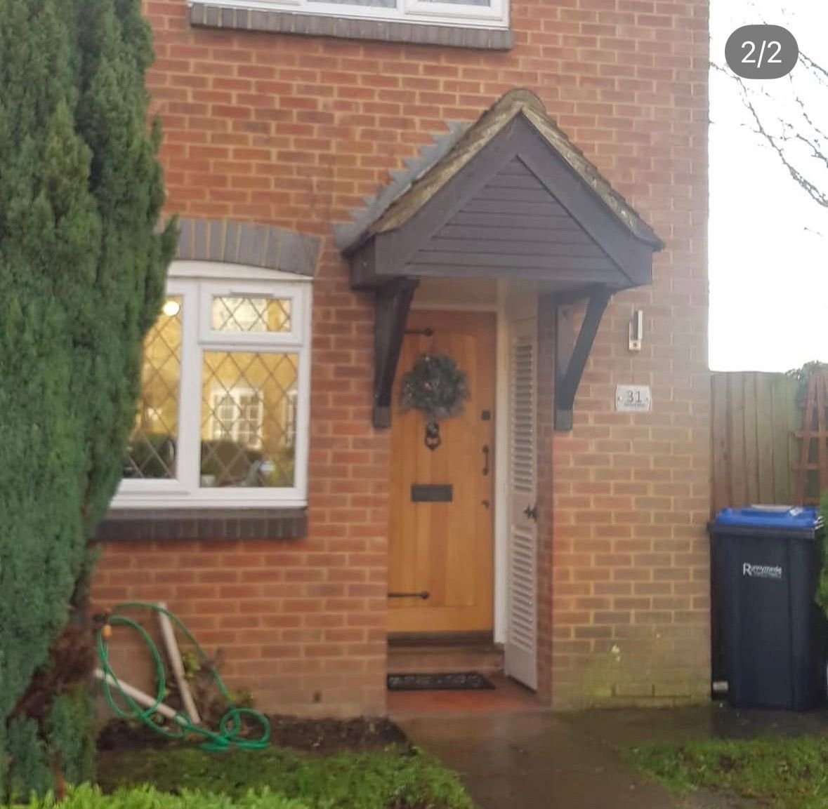 Timber front door on a brick house