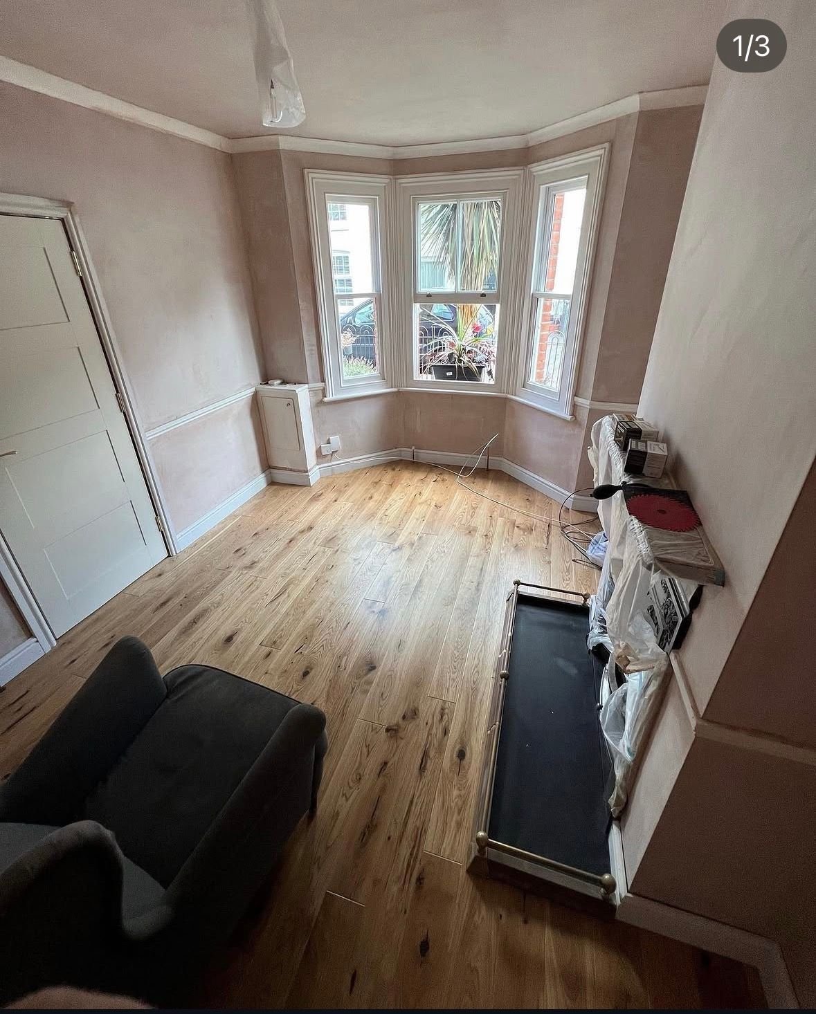 Wood floor in a living room with a bay window