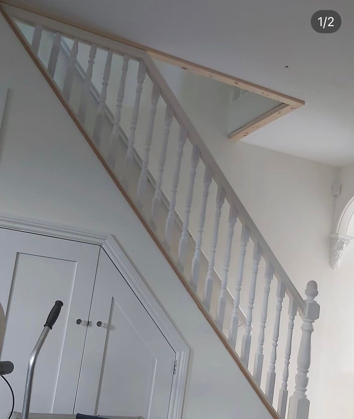 White staircase with panelled under-stairs