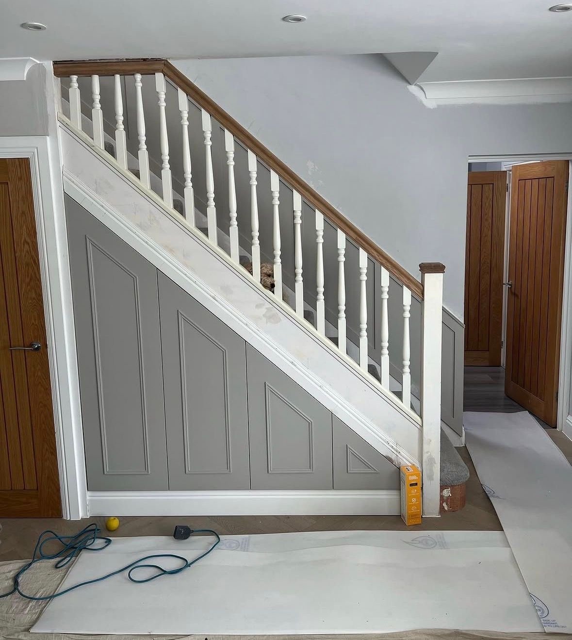 Staircase with panelled under-stairs storage