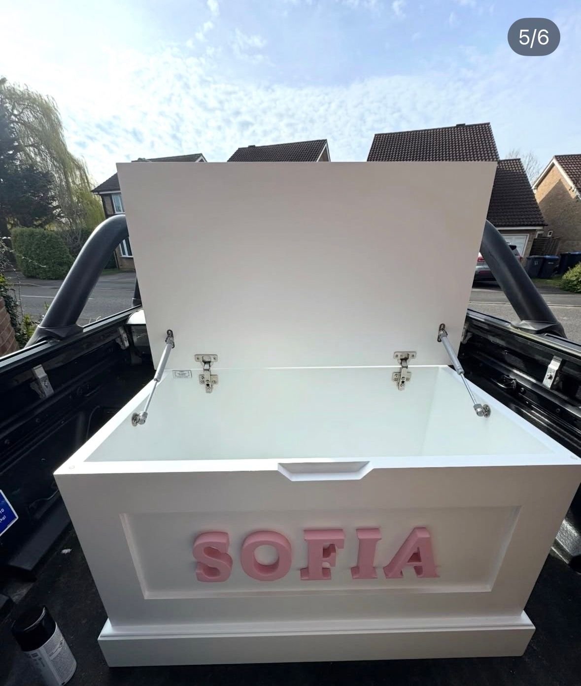 Personalised toy box with the lid open showing storage